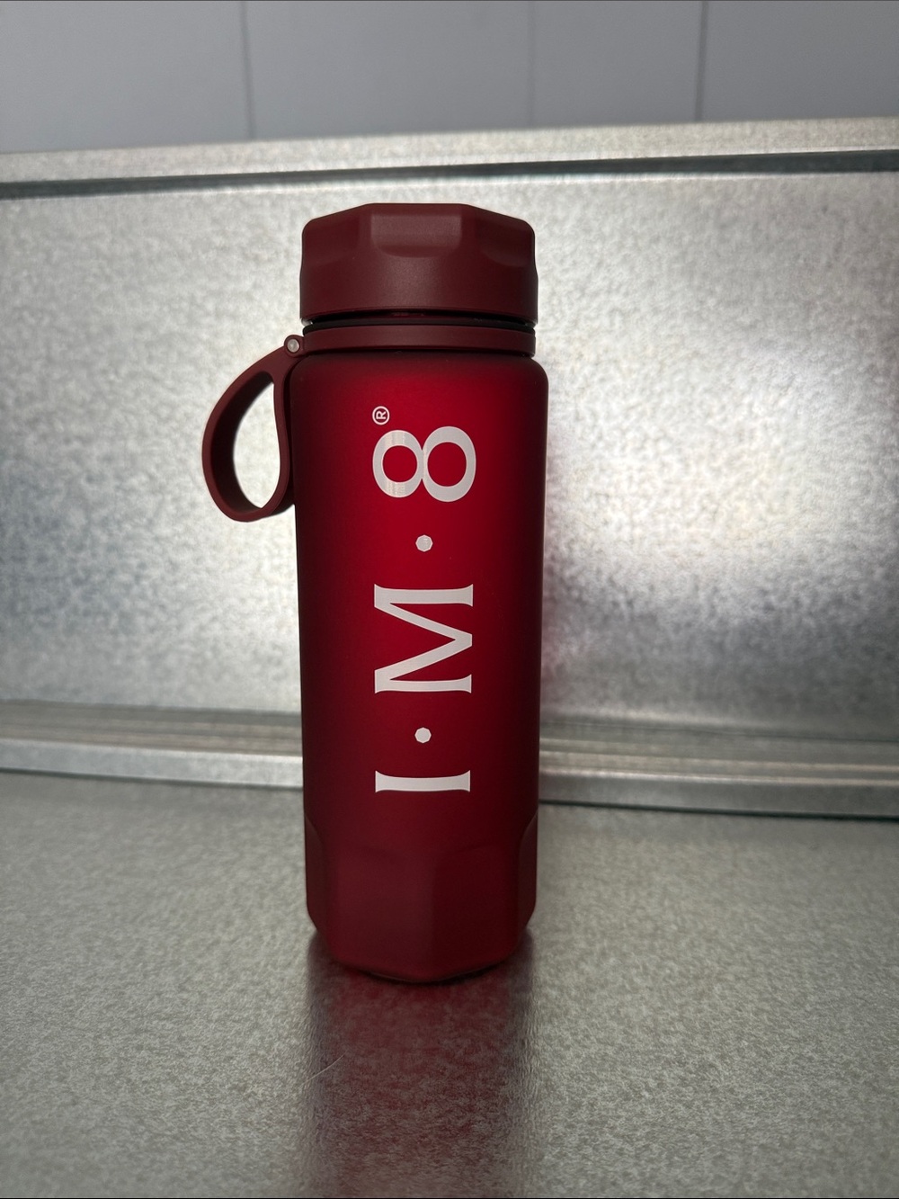 IM8 Crimson Water Bottle with Measurement Markings.